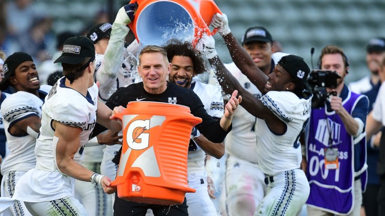 Dec 4, 2021; Carson, CA, USA; Utah State Aggies players pour gatorade on Utah State Aggies head coach Blake Anderson in celebration of the victory against San Diego State Aztecs in the Mountain West Conference championship game at Dignity Health Sports Park. Mandatory Credit: Gary A. Vasquez-USA TODAY Sports