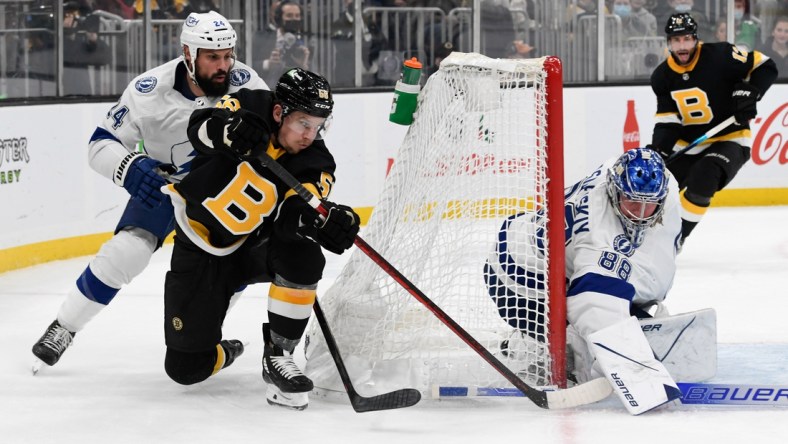 Dec 4, 2021; Boston, Massachusetts, USA; Tampa Bay Lightning goaltender Andrei Vasilevskiy (88) blocks a  attempts a wrap-around shot from Boston Bruins left wing Erik Haula (56) during the first period at TD Garden. Mandatory Credit: Brian Fluharty-USA TODAY Sports