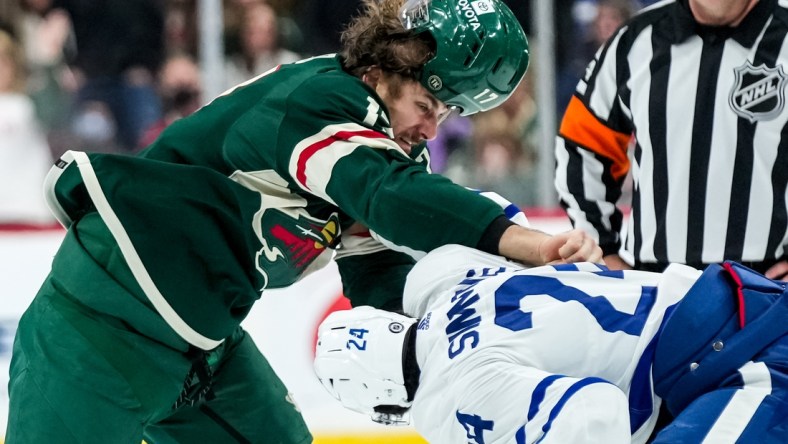 Dec 4, 2021; Saint Paul, Minnesota, USA; Minnesota Wild forward Marcus Foligno (17) fights Toronto Maple Leafs forward Wayne Simmonds (24) during the first period at Xcel Energy Center. Mandatory Credit: Brace Hemmelgarn-USA TODAY Sports