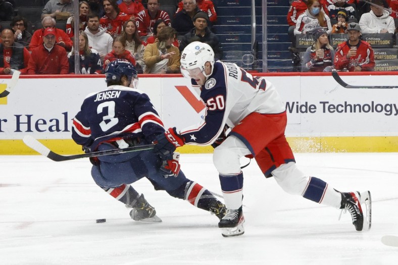 Dec 4, 2021; Washington, District of Columbia, USA; Columbus Blue Jackets left wing Eric Robinson (50) skates with the puck around Washington Capitals defenseman Nick Jensen (3) during the second period at Capital One Arena. Mandatory Credit: Geoff Burke-USA TODAY Sports