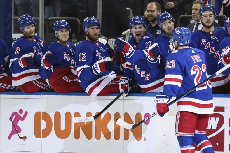 Dec 4, 2021; New York, New York, USA; New York Rangers defenseman Adam Fox (23) celebrates with teammates after scoring a goal against the Chicago Blackhawks in the second period at Madison Square Garden. Mandatory Credit: Wendell Cruz-USA TODAY Sports