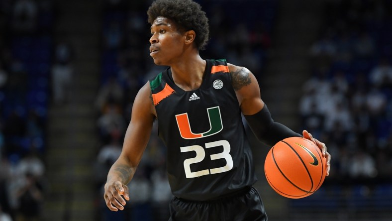 Dec 1, 2021; University Park, Pennsylvania, USA; Miami Hurricanes guard Kameron McGusty (23) controls the ball against the Penn State Nittany Lions during the second half at the Bryce Jordan Center. Mandatory Credit: Rich Barnes-USA TODAY Sports