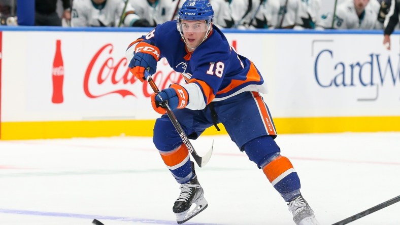 Dec 2, 2021; Elmont, New York, USA; New York Islanders left wing Anthony Beauvillier (18) passes the puck against San Jose Sharks during the second period at UBS Arena. Mandatory Credit: Tom Horak-USA TODAY Sports