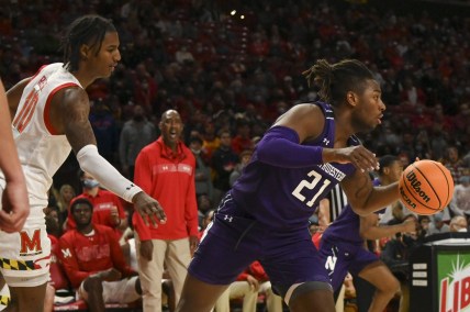 Dec 5, 2021; College Park, Maryland, USA;  Northwestern Wildcats forward Elyjah Williams (21) dribbles away from Maryland Terrapins forward Julian Reese (10) during the second half at Xfinity Center. Mandatory Credit: Tommy Gilligan-USA TODAY Sports