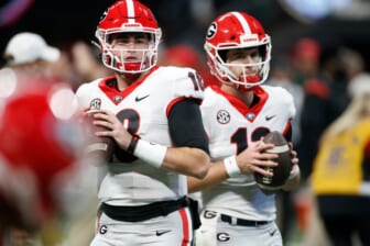 Georgia quarterback JT Daniels (18) and Georgia quarterback Stetson Bennett (13) warm up before the start the Southeastern Conference championship NCAA college football game between Georgia and Alabama in Atlanta, on Saturday, Dec. 4, 2021.Syndication Online Athens