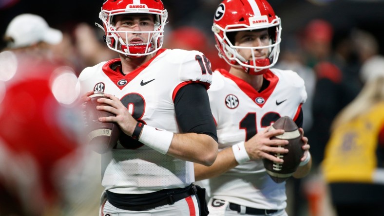 Georgia quarterback JT Daniels (18) and Georgia quarterback Stetson Bennett (13) warm up before the start the Southeastern Conference championship NCAA college football game between Georgia and Alabama in Atlanta, on Saturday, Dec. 4, 2021.

Syndication Online Athens