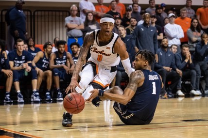 Dec 5, 2021; Stillwater, Oklahoma, USA; Oklahoma State Cowboys guard Avery Anderson III (0) dribbles past Xavier Musketeers guard Paul Scruggs (1) during the first half at Gallagher-Iba Arena. Mandatory Credit: Rob Ferguson-USA TODAY Sports