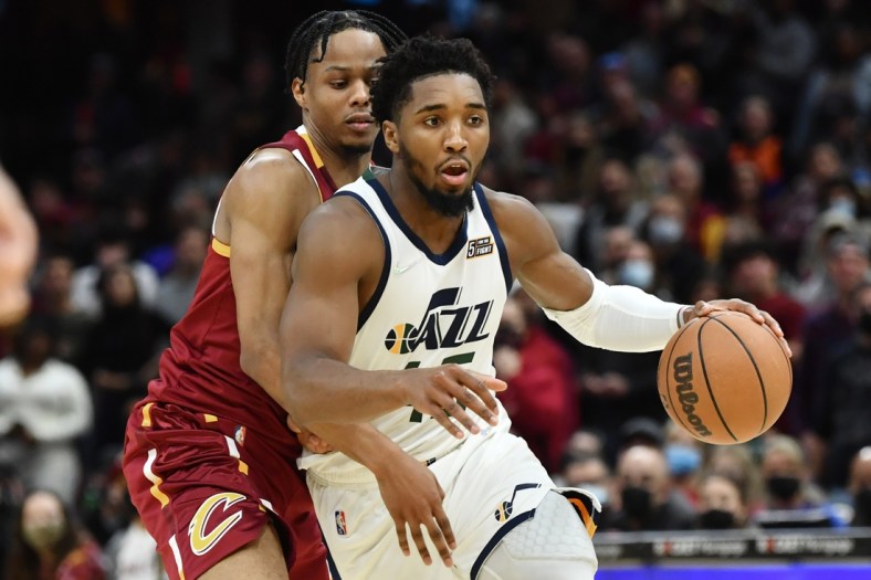 Dec 5, 2021; Cleveland, Ohio, USA; Utah Jazz guard Donovan Mitchell (45) drives to the basket against Cleveland Cavaliers forward Isaac Okoro (35) during the second half at Rocket Mortgage FieldHouse. Mandatory Credit: Ken Blaze-USA TODAY Sports