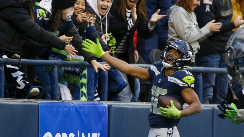 Dec 5, 2021; Seattle, Washington, USA; Seattle Seahawks wide receiver Tyler Lockett (16) celebrates with fans after catching a touchdown pass against the San Francisco 49ers during the third quarter at Lumen Field. Mandatory Credit: Joe Nicholson-USA TODAY Sports