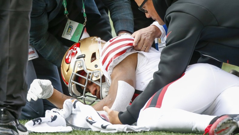 Dec 5, 2021; Seattle, Washington, USA; San Francisco 49ers running back Trenton Cannon (49) is attended to after being injured against the Seattle Seahawks during the first quarter at Lumen Field. Mandatory Credit: Joe Nicholson-USA TODAY Sports