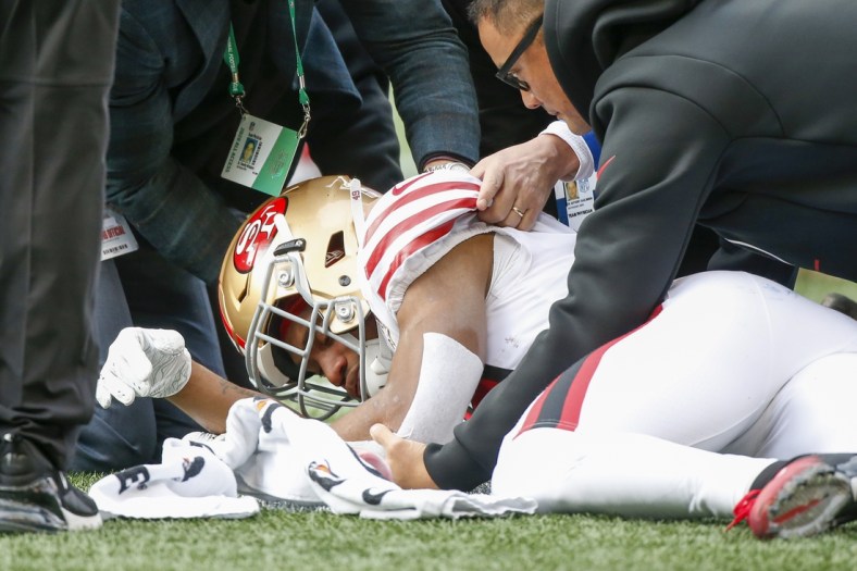 Dec 5, 2021; Seattle, Washington, USA; San Francisco 49ers running back Trenton Cannon (49) is attended to after being injured against the Seattle Seahawks during the first quarter at Lumen Field. Mandatory Credit: Joe Nicholson-USA TODAY Sports