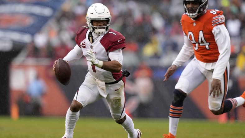 Dec 5, 2021; Chicago, Illinois, USA; Arizona Cardinals quarterback Kyler Murray (1) avoids the tackle of Chicago Bears outside linebacker Robert Quinn (94) during the first quarter at Soldier Field. Mandatory Credit: Mike Dinovo-USA TODAY Sports