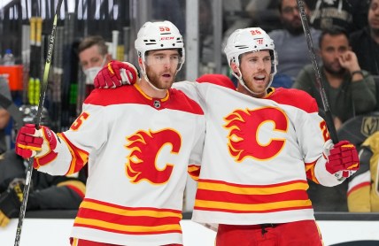 Dec 5, 2021; Las Vegas, Nevada, USA;Calgary Flames center Elias Lindholm (28) celebrates with Calgary Flames defenseman Noah Hanifin (55) after scoring a third period goal against the Vegas Golden Knights at T-Mobile Arena. Mandatory Credit: Stephen R. Sylvanie-USA TODAY Sports