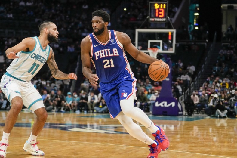 Dec 6, 2021; Charlotte, North Carolina, USA; Philadelphia 76ers center Joel Embiid (21) drives to the basket against Charlotte Hornets forward Cody Martin (11) during the first period at the Spectrum Center. Mandatory Credit: Jim Dedmon-USA TODAY Sports