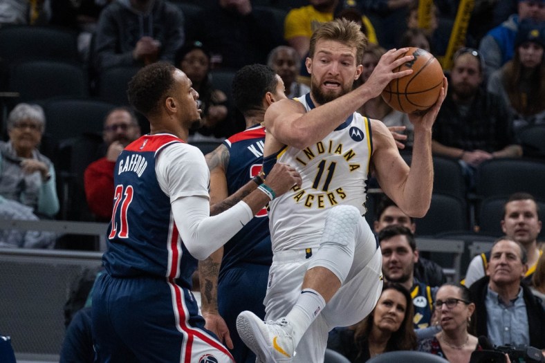 Dec 6, 2021; Indianapolis, Indiana, USA; Indiana Pacers forward Domantas Sabonis (11) rebounds the ball over Washington Wizards center Daniel Gafford (21) in the first quarter at Gainbridge Fieldhouse. Mandatory Credit: Trevor Ruszkowski-USA TODAY Sports