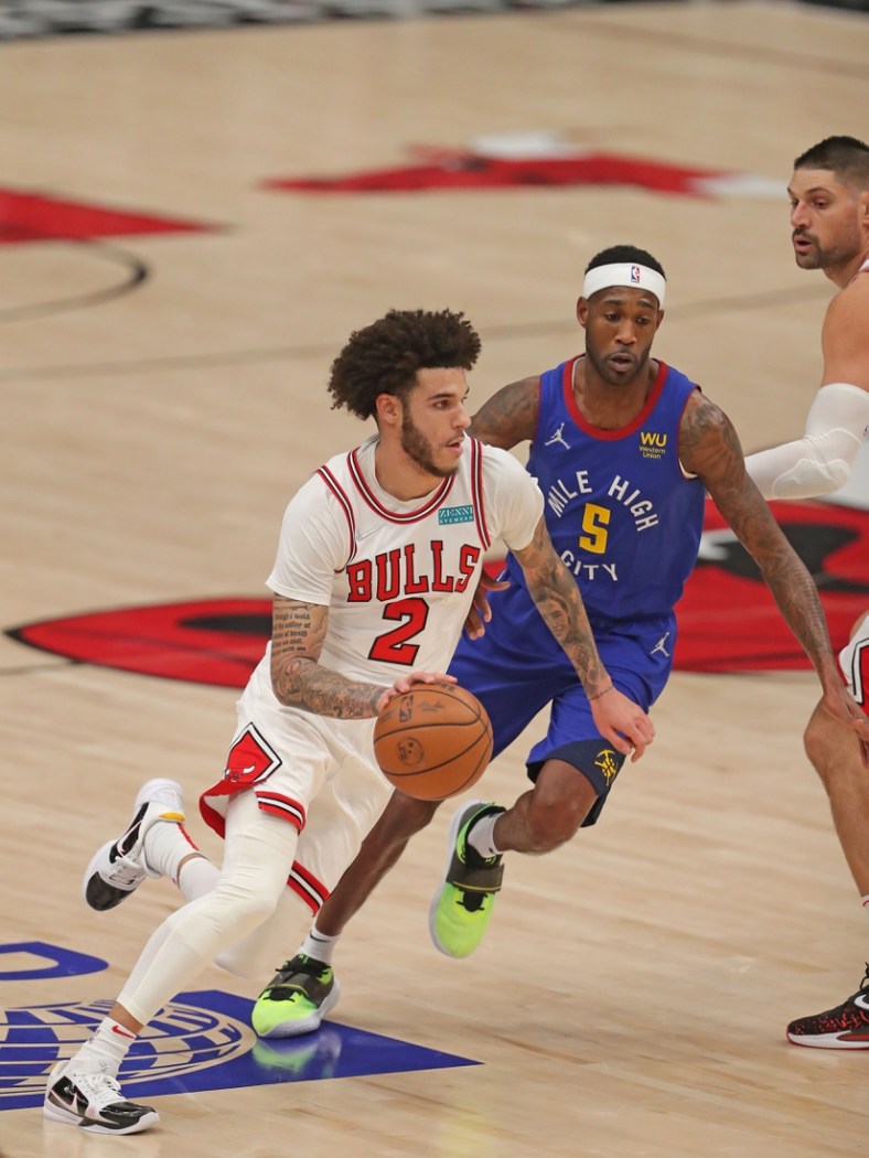Dec 6, 2021; Chicago, Illinois, USA; Chicago Bulls guard Lonzo Ball (2) drives around Denver Nuggets forward Will Barton (5) during the first quarter at the United Center. Mandatory Credit: Dennis Wierzbicki-USA TODAY Sports