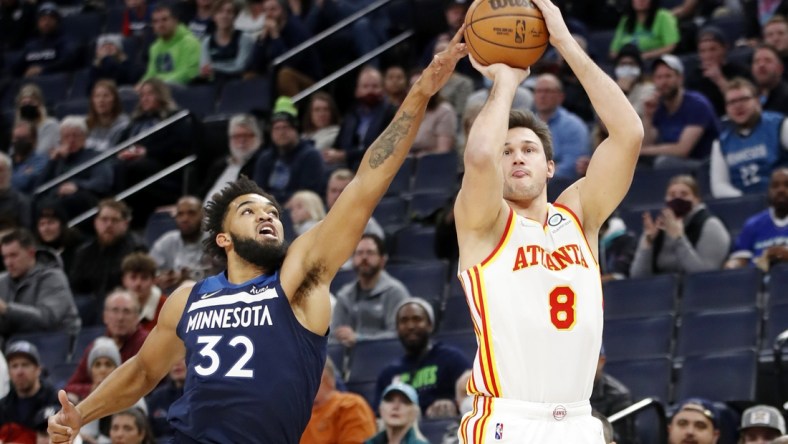 Dec 6, 2021; Minneapolis, Minnesota, USA; Atlanta Hawks forward Danilo Gallinari (8) shoots as Minnesota Timberwolves center Karl-Anthony Towns (32) tries tro defend him in the first quarter at Target Center. Mandatory Credit: Bruce Kluckhohn-USA TODAY Sports