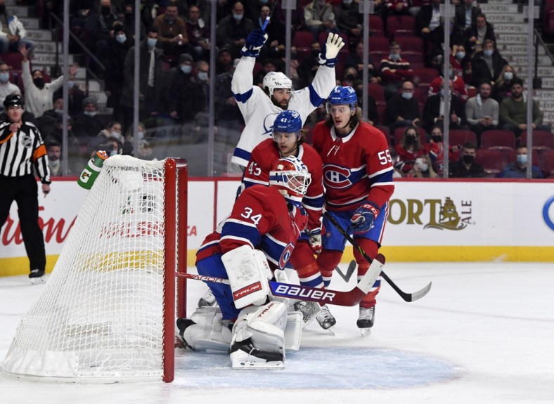 Dec 7, 2021; Montreal, Quebec, CAN; Tampa Bay Lightning forward Pat Maroon (14) celebrates next to Montreal Canadiens defenseman Kale Clague (43) and teammate forward Michael Pezzetta (55) after scoring a goal against goalie Jake Allen (34) during the first period at the Bell Centre. Mandatory Credit: Eric Bolte-USA TODAY Sports