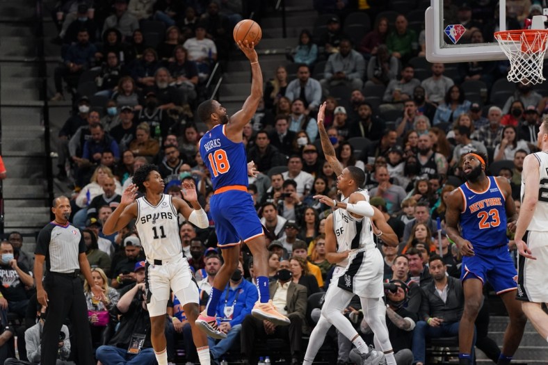 Dec 7, 2021; San Antonio, Texas, USA;  New York Knicks guard Alec Burks (18) shoots over San Antonio Spurs guard Dejounte Murray (5) in the first half at the AT&T Center. Mandatory Credit: Daniel Dunn-USA TODAY Sports