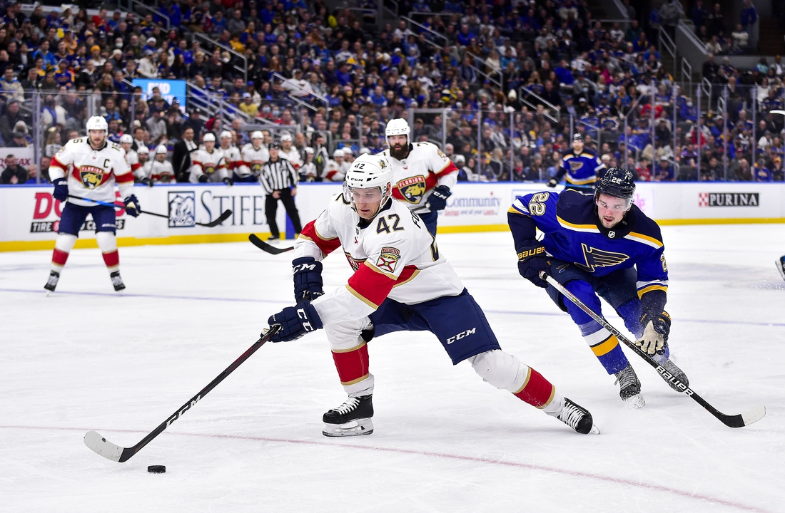 Dec 7, 2021; St. Louis, Missouri, USA;  Florida Panthers defenseman Gustav Forsling (42) controls the puck as St. Louis Blues center Logan Brown (22) defends during the second period at Enterprise Center. Mandatory Credit: Jeff Curry-USA TODAY Sports