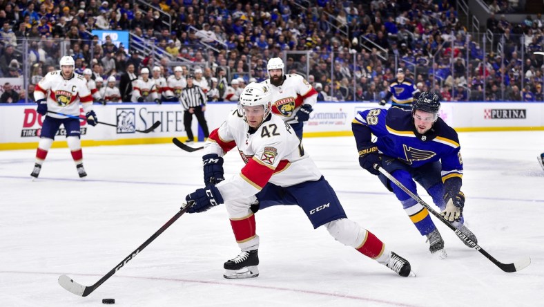 Dec 7, 2021; St. Louis, Missouri, USA;  Florida Panthers defenseman Gustav Forsling (42) controls the puck as St. Louis Blues center Logan Brown (22) defends during the second period at Enterprise Center. Mandatory Credit: Jeff Curry-USA TODAY Sports