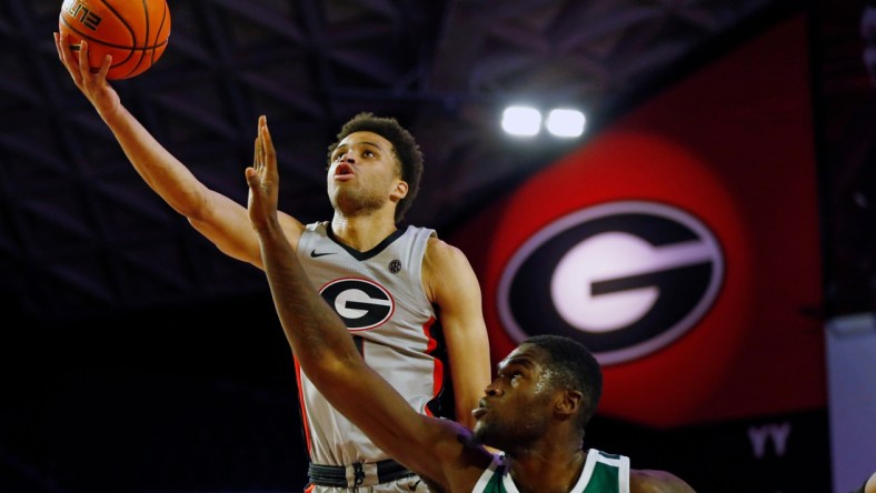 Georgia's Jabri Abdur-Rahim (1) takes a shot over Jacksonville forward Mike Marsh (12) during an NCAA basketball game between Jacksonville and Georgia in Athens, Ga., on Tuesday, Dec. 7, 2021. Georgia won 69-58.