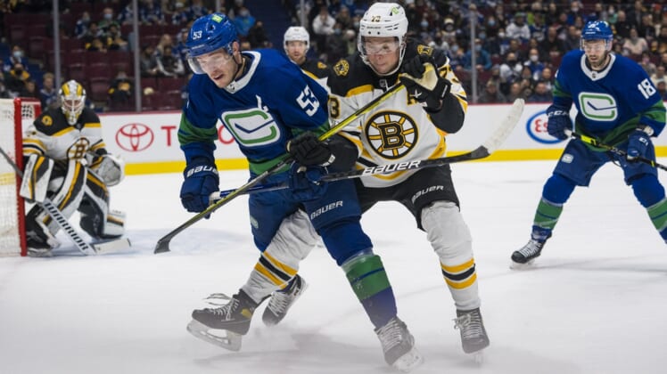 Dec 8, 2021; Vancouver, British Columbia, CAN; Boston Bruins defenseman Charlie McAvoy (73) checks Vancouver Canucks forward Bo Horvat (53) in the first period at Rogers Arena. Mandatory Credit: Bob Frid-USA TODAY Sports