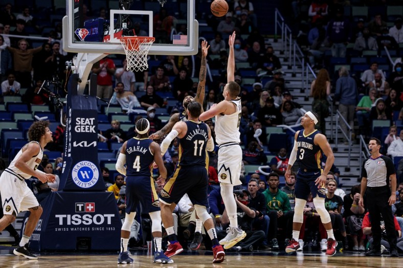 Dec 8, 2021; New Orleans, Louisiana, USA;  Denver Nuggets center Nikola Jokic (15) shoots a jump shot over New Orleans Pelicans forward Brandon Ingram (14) during the second half at Smoothie King Center. Mandatory Credit: Stephen Lew-USA TODAY Sports