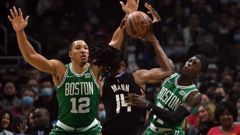 Dec 8, 2021; Los Angeles, California, USA; Los Angeles Clippers guard Terance Mann (14) moves the ball against Boston Celtics forward Grant Williams (12) and guard Dennis Schroder (71) during the first half at Staples Center. Mandatory Credit: Jayne Kamin-Oncea-USA TODAY Sports