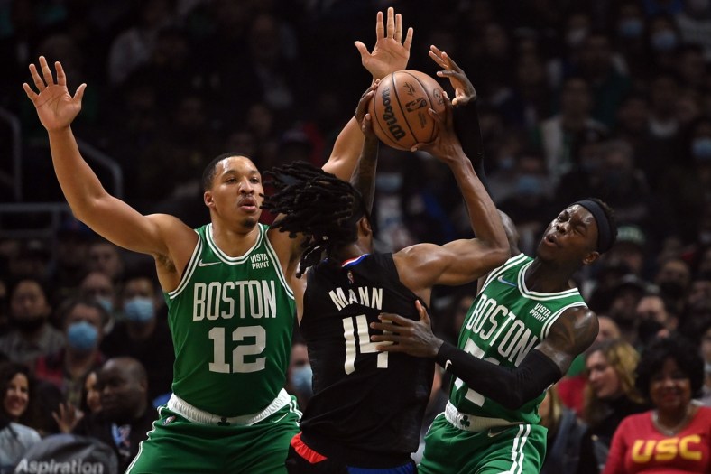 Dec 8, 2021; Los Angeles, California, USA; Los Angeles Clippers guard Terance Mann (14) moves the ball against Boston Celtics forward Grant Williams (12) and guard Dennis Schroder (71) during the first half at Staples Center. Mandatory Credit: Jayne Kamin-Oncea-USA TODAY Sports