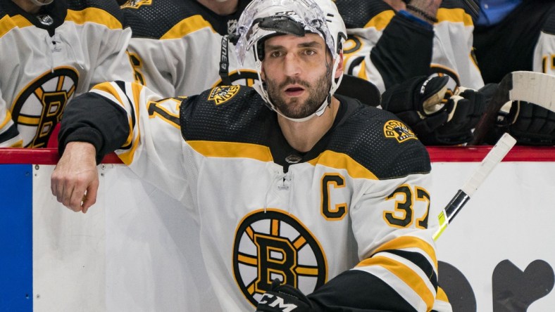 Dec 8, 2021; Vancouver, British Columbia, CAN; A tired Boston Bruins forward Patrice Bergeron (37) relaxes at the end of the overtime period against the Vancouver Canucks at Rogers Arena. Vancouver won 2-1 in Overtime. Mandatory Credit: Bob Frid-USA TODAY Sports