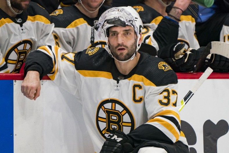 Dec 8, 2021; Vancouver, British Columbia, CAN; A tired Boston Bruins forward Patrice Bergeron (37) relaxes at the end of the overtime period against the Vancouver Canucks at Rogers Arena. Vancouver won 2-1 in Overtime. Mandatory Credit: Bob Frid-USA TODAY Sports