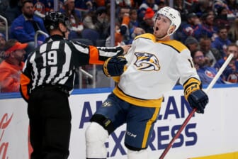 Dec 9, 2021; Elmont, New York, USA; Nashville Predators center Colton Sissons (10) celebrates his goal against the New York Islanders in front of referee Gord Dwyer (19) during the first period at UBS Arena. Mandatory Credit: Brad Penner-USA TODAY Sports
