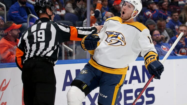 Dec 9, 2021; Elmont, New York, USA; Nashville Predators center Colton Sissons (10) celebrates his goal against the New York Islanders in front of referee Gord Dwyer (19) during the first period at UBS Arena. Mandatory Credit: Brad Penner-USA TODAY Sports