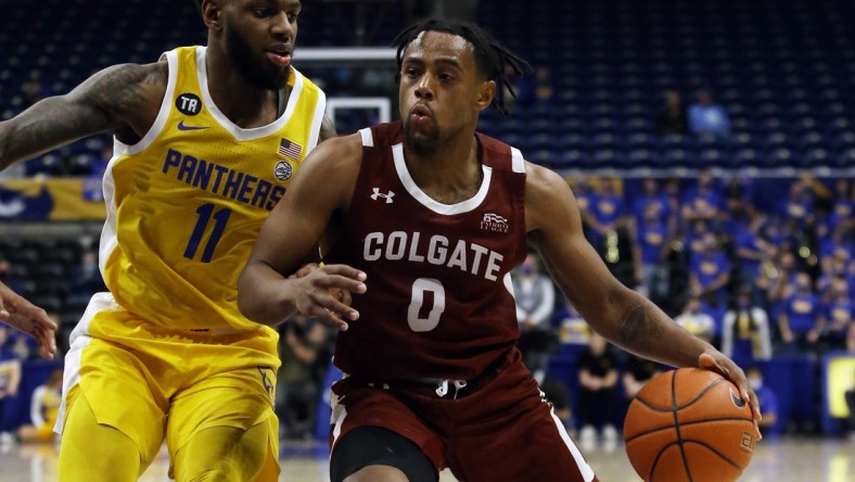 Dec 9, 2021; Pittsburgh, Pennsylvania, USA; Colgate Raiders guard Nelly Cummings (0) goes to the basket against Pittsburgh Panthers guard Jamarius Burton (11) during the first half at the Petersen Events Center. Mandatory Credit: Charles LeClaire-USA TODAY Sports