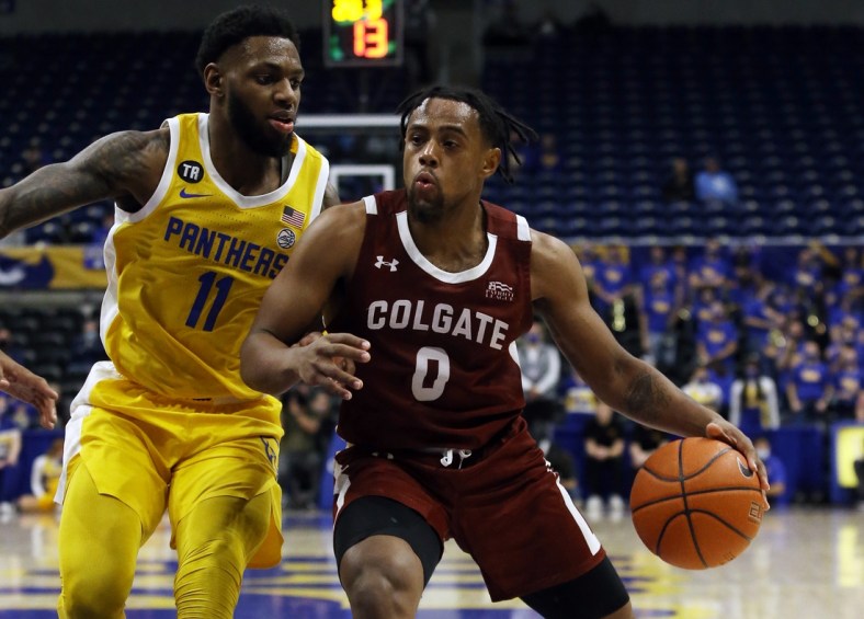 Dec 9, 2021; Pittsburgh, Pennsylvania, USA; Colgate Raiders guard Nelly Cummings (0) goes to the basket against Pittsburgh Panthers guard Jamarius Burton (11) during the first half at the Petersen Events Center. Mandatory Credit: Charles LeClaire-USA TODAY Sports