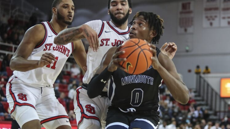 Dec 9, 2021; Queens, New York, USA;  Monmouth Hawks forward Myles Foster (0) is double teamed by St. John   s Red Storm forward Julian Champagnie (2) and center Joel Soriano (11) in the fist half at Carnesecca Arena. Mandatory Credit: Wendell Cruz-USA TODAY Sports