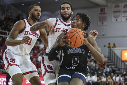 Dec 9, 2021; Queens, New York, USA;  Monmouth Hawks forward Myles Foster (0) is double teamed by St. John   s Red Storm forward Julian Champagnie (2) and center Joel Soriano (11) in the fist half at Carnesecca Arena. Mandatory Credit: Wendell Cruz-USA TODAY Sports