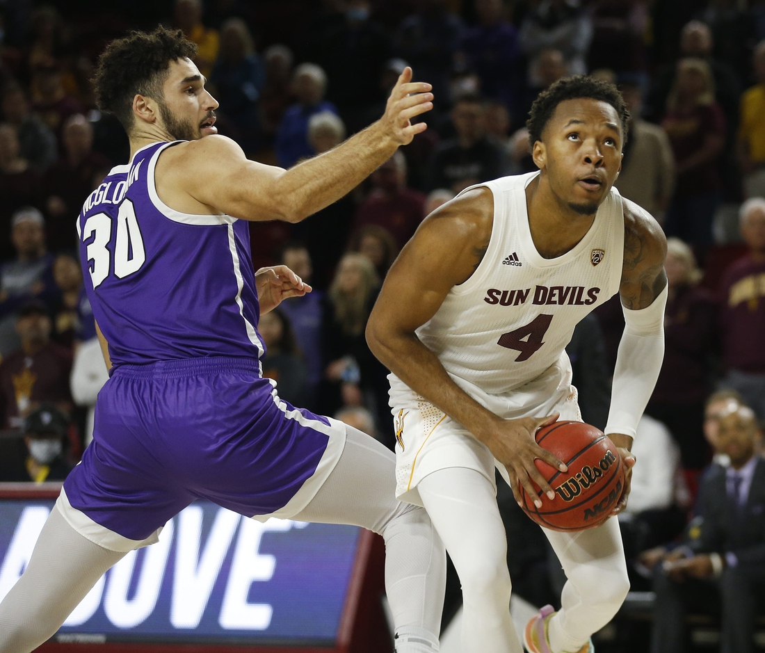 Dec 9, 2021; Tempe, AZ, United States; ASU's Kimani Lawrence (4) spins around GCU's Gabe McGlothan (30) during a game at Desert Financial Arena. Mandatory Credit: Patrick Breen-Arizona Republic

Asu V Gcu