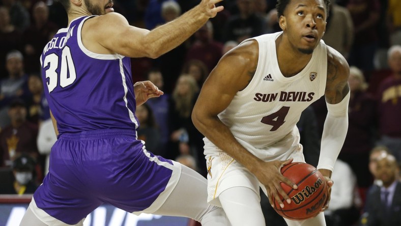 Dec 9, 2021; Tempe, AZ, United States; ASU's Kimani Lawrence (4) spins around GCU's Gabe McGlothan (30) during a game at Desert Financial Arena. Mandatory Credit: Patrick Breen-Arizona Republic

Asu V Gcu