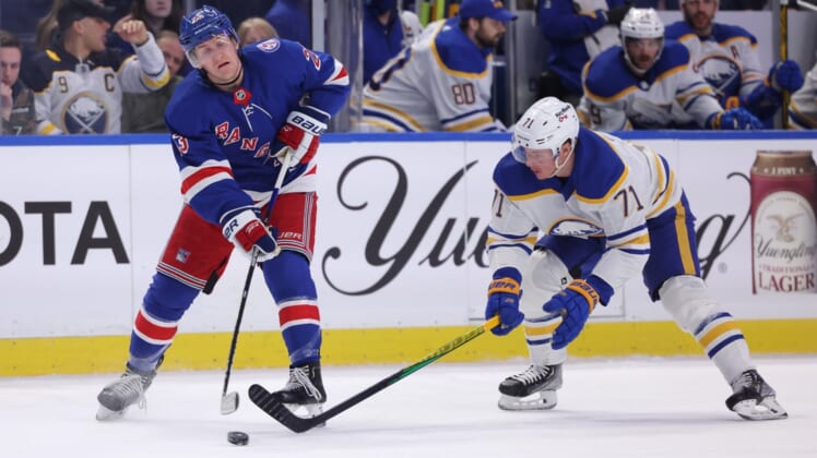 Dec 10, 2021; Buffalo, New York, USA;  Buffalo Sabres right wing Victor Olofsson (71) tries to block a pass by New York Rangers defenseman Adam Fox (23) during the second period at KeyBank Center. Mandatory Credit: Timothy T. Ludwig-USA TODAY Sports