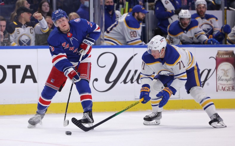 Dec 10, 2021; Buffalo, New York, USA;  Buffalo Sabres right wing Victor Olofsson (71) tries to block a pass by New York Rangers defenseman Adam Fox (23) during the second period at KeyBank Center. Mandatory Credit: Timothy T. Ludwig-USA TODAY Sports