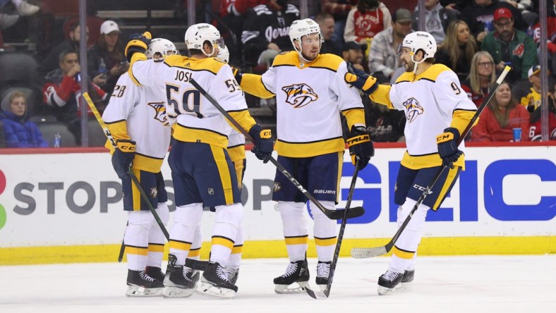 Dec 10, 2021; Newark, New Jersey, USA; Nashville Predators right wing Eeli Tolvanen (28) celebrates his goal against the New Jersey Devils during the second period at Prudential Center. Mandatory Credit: Ed Mulholland-USA TODAY Sports