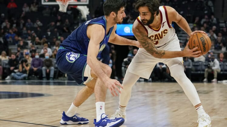 Dec 10, 2021; Minneapolis, Minnesota, USA;  Cleveland Cavaliers guard Ricky Rubio (3) controls the ball as Minnesota Timberwolves guard Leandro Bolmaro (9) defends during the first quarter at Target Center. Mandatory Credit: Nick Wosika-USA TODAY Sports