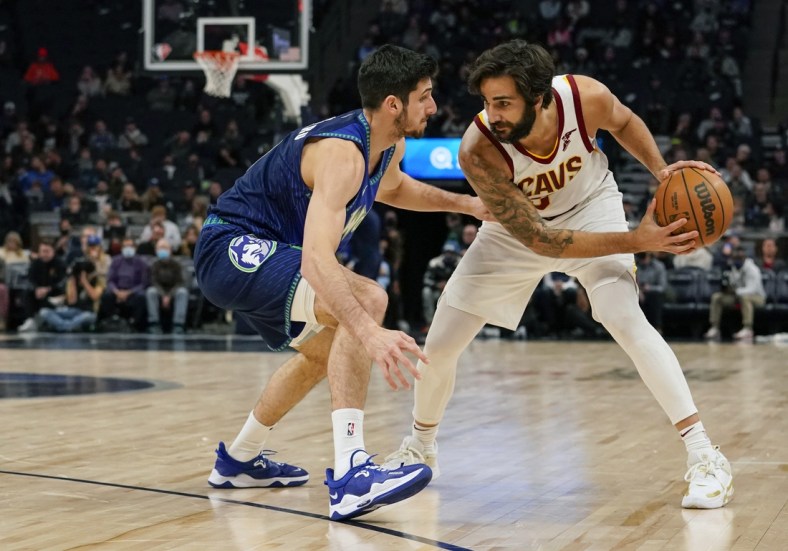 Dec 10, 2021; Minneapolis, Minnesota, USA;  Cleveland Cavaliers guard Ricky Rubio (3) controls the ball as Minnesota Timberwolves guard Leandro Bolmaro (9) defends during the first quarter at Target Center. Mandatory Credit: Nick Wosika-USA TODAY Sports
