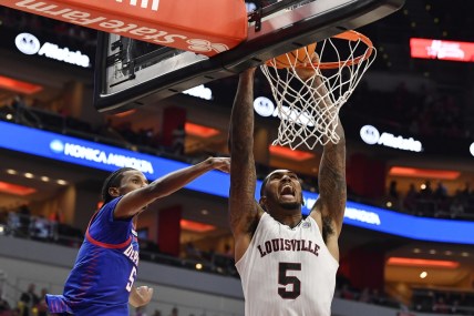 Dec 10, 2021; Louisville, Kentucky, USA;  Louisville Cardinals forward Malik Williams (5) dunks against DePaul Blue Demons guard Philmon Gebrewhit (5) during the second half at KFC Yum! Center. DePaul defeated Louisville 62-55. Mandatory Credit: Jamie Rhodes-USA TODAY Sports