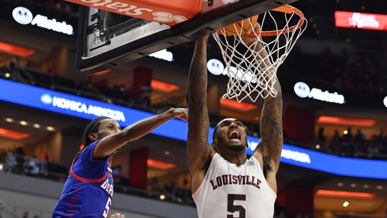 Dec 10, 2021; Louisville, Kentucky, USA;  Louisville Cardinals forward Malik Williams (5) dunks against DePaul Blue Demons guard Philmon Gebrewhit (5) during the second half at KFC Yum! Center. DePaul defeated Louisville 62-55. Mandatory Credit: Jamie Rhodes-USA TODAY Sports