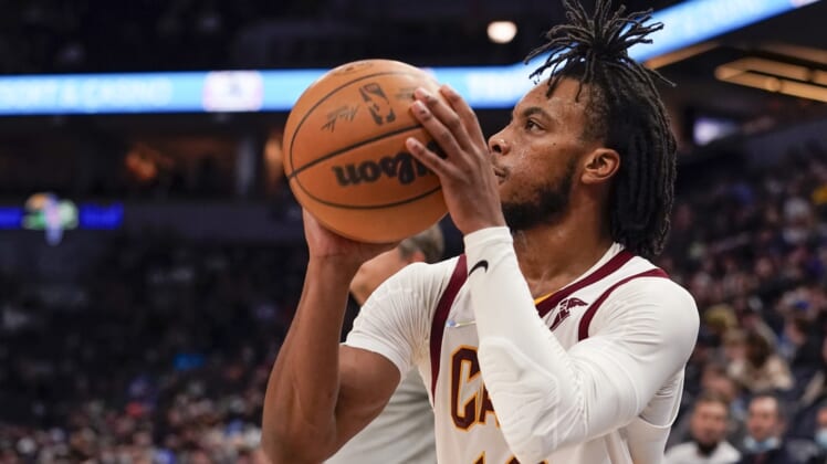 Dec 10, 2021; Minneapolis, Minnesota, USA;  Cleveland Cavaliers guard Darius Garland (10) hits a three-pointer against the Minnesota Timberwolves during the fourth quarter at Target Center. Mandatory Credit: Nick Wosika-USA TODAY Sports
