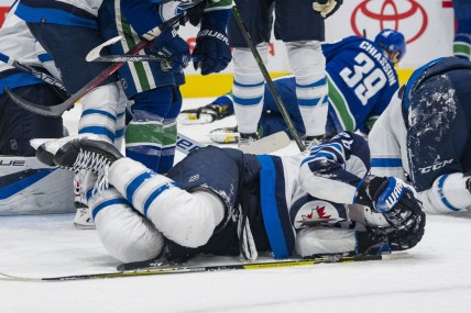 Dec 10, 2021; Vancouver, British Columbia, CAN; Winnipeg Jets forward Blake Wheeler (26) lays on the ice injured against the Vancouver Canucks in the third period at Rogers Arena. Vancouver wins 4-3 in a shootout. Mandatory Credit: Bob Frid-USA TODAY Sports