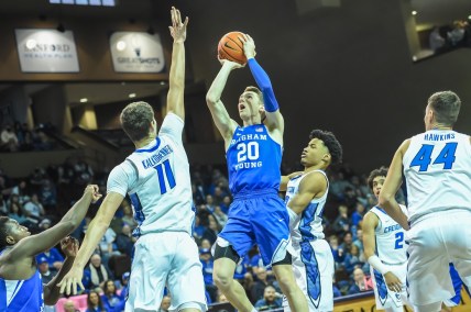 Dec 11, 2021; Sioux Falls, South Dakota, USA;  Brigham Young Cougars guard Spencer Johnson (20) attempts a shot against Creighton Bluejays center Ryan Kalkbrenner (11) in the first half at Sanford Pentagon. Mandatory Credit: Steven Branscombe-USA TODAY Sports
